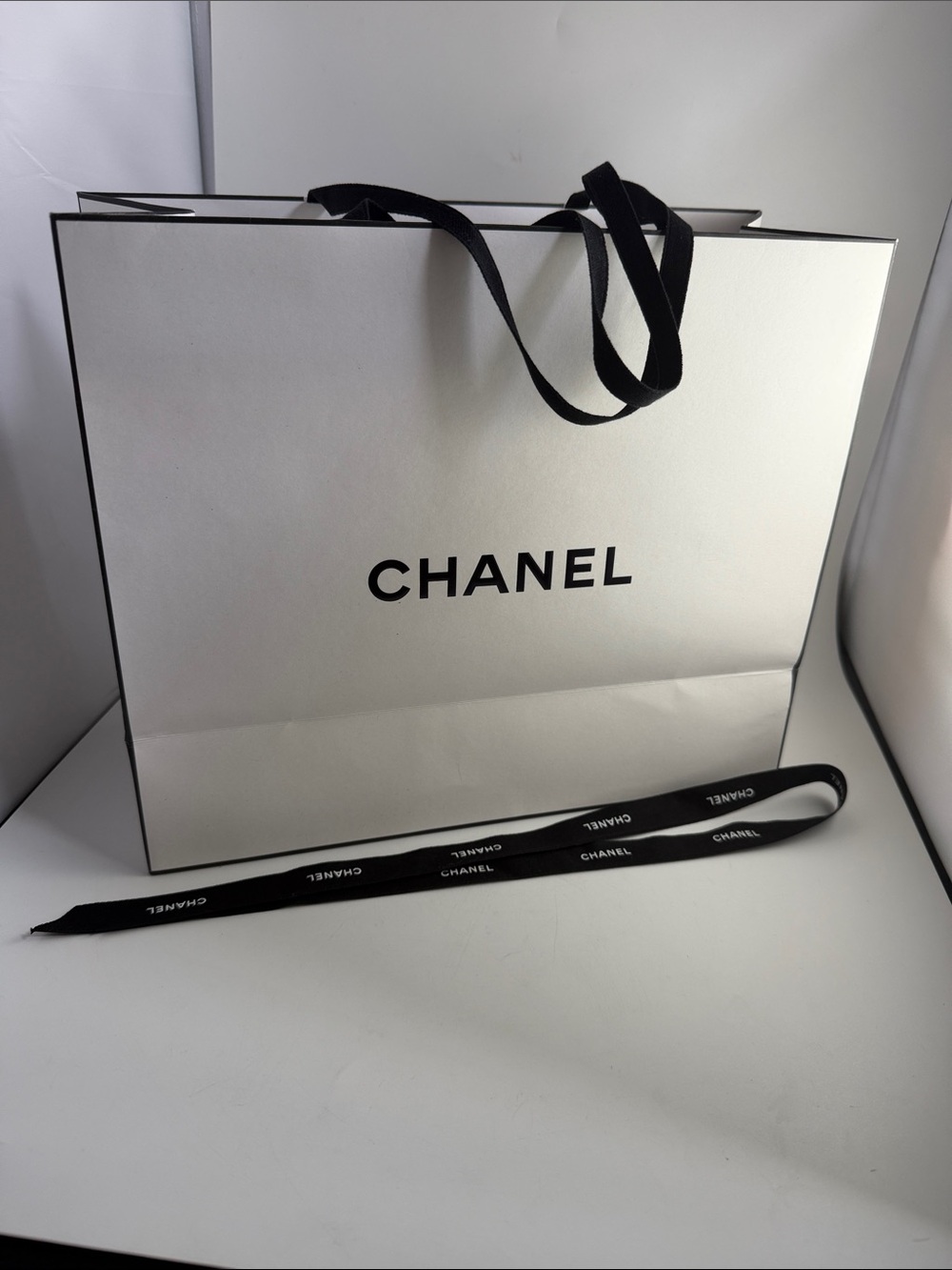 Authentic Chanel Paper gift bag with ribbon.